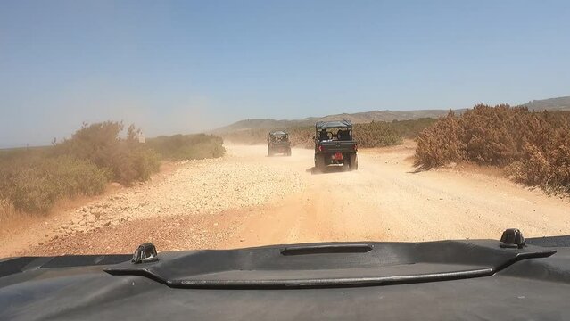 Offroad jeeps racing on a dirt road of Akamas peninsula