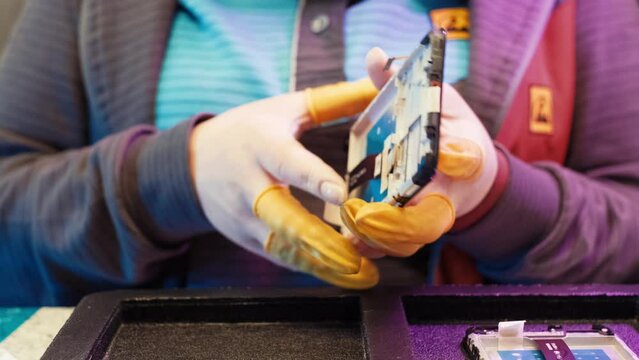 Assembling a mobile device. Repair of equipment and phones. close up of worker hands . 4K
