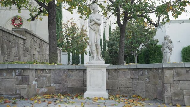 Panorama view of statues of a half naked women in the park