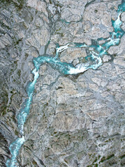Wild river with rapids flowing mountain landscape aerial view