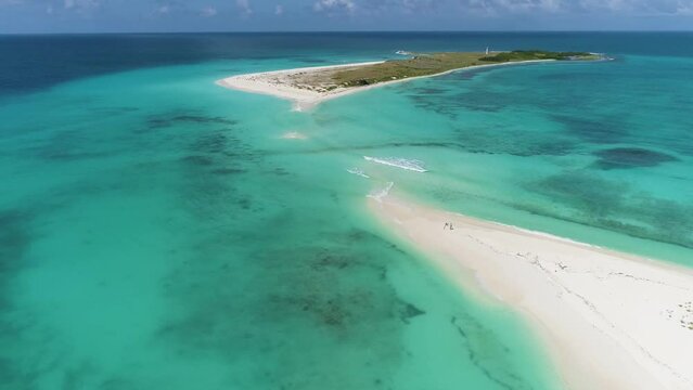 Drone stunning landscape couple stand on long and narrow strip of white sand, Cayo  Agua island Los Roques