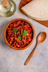Chili Con Carne in bowl on dark background.