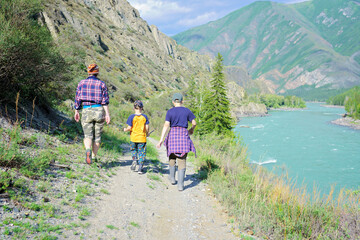 Adult woman and children hiking in the mountains