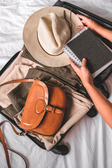 Travel. Staycation.local travel new normal.Girl traveler packing luggage in suitcase...