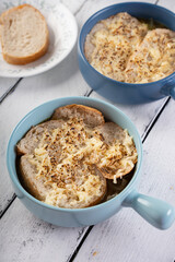 a bowl of hot French onion soup with mozzarella cheese and french bed on top