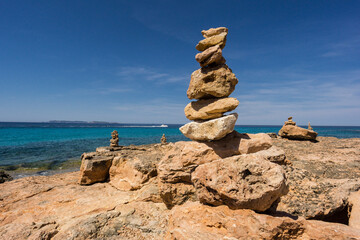 Fototapeta na wymiar piedras en equilibrio frente a la isla de Cabrera, punta des Milà, Ses Salines, Mallorca, Balearic Islands, Spain