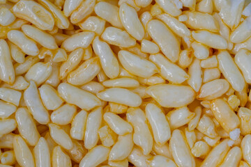 Puffed honey rice - macro, close up, top view. Oriental sweet, texture, gastronomy and Asian food concept