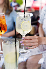 Female holding aperitif at dinner table