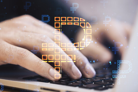 Close up of hands using laptop on desktop with creative glowing Russian ruble hologram on blurry background. Digital money and online banking concept. Double exposure.