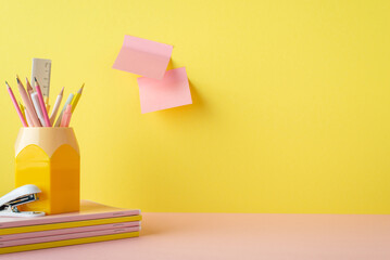Back to school concept. Photo of pink and yellow school supplies stand for pencils stapler stack of...