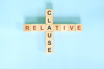 Relative clause concept in English grammar education. Wooden block crossword puzzle flat lay in...