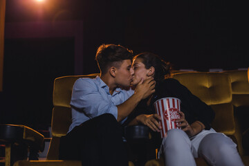 Young couple kissing in the cinema.