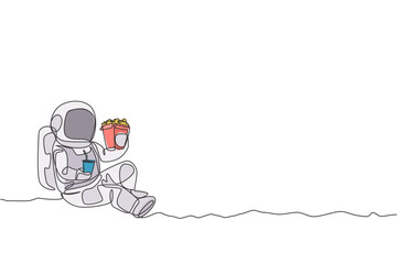Single continuous line drawing of spaceman sitting relax on moon surface while eating french fries and drinking soft soda. Outer space life concept. Trendy one line draw design vector illustration