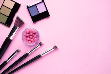 Creative concept beauty fashion photo of cosmetic product make up brushes kit on pink background.