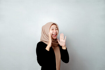 Photo For Promotion. Portrait of Asian hijab woman stretching her arms and showing expression. This photo is suitable for promotional use.