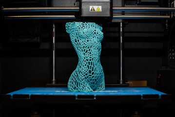 3d printer prints the model of female body, process of creating a bust of girl on 3d printer.