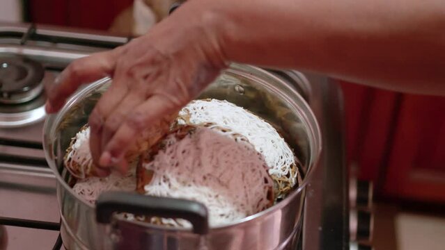Making some Idiyappam, a traditional dish in Sri Lanka. Inside of a kitchen, making the traditional rice noodle dish.