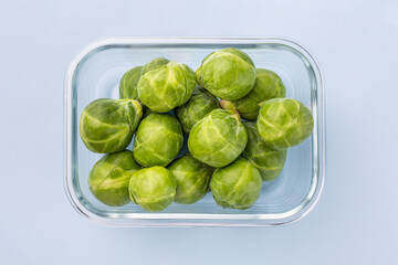 Glass box with fresh brussels sprouts.  Vegetables in a glass containers. Food storage concept
