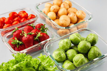 Glass boxes with fresh raw vegetables.  Vegetables and fruits in glass containers. Food storage concept