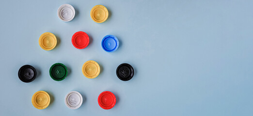 Plastic bottle caps background. Cap material is recyclable. Recycling collection and processing plastic bottle caps. Pollution, environmental protection concept