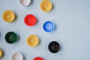 Plastic bottle caps background. Cap material is recyclable. Recycling collection and processing plastic bottle caps. Pollution, environmental protection concept