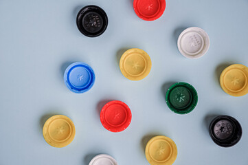 Plastic bottle caps background. Cap material is recyclable. Recycling collection and processing plastic bottle caps. Pollution, environmental protection concept