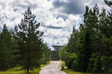 Fototapeta na wymiar A huge soviet radio telescope near abandoned Soviet Union military ghost town Irbene in Latvia