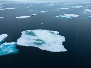 Drifting pack ice in the Arctic Ocean. The snow-capped blue glacial ice is a pristine wilderness, but one that is rapidly melting due to climate change. Nordaustlandet, Svalbard, Norway