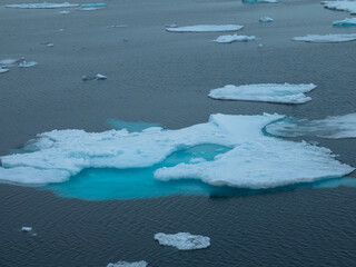 Drifting pack ice in the Arctic Ocean. The snow-capped blue glacial ice is a pristine wilderness, but one that is rapidly melting due to climate change. Nordaustlandet, Svalbard, Norway © familie-eisenlohr.de