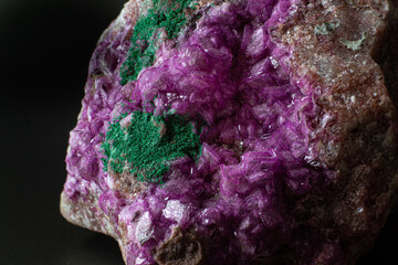 Cobalto calcite with malachite crystal macro on a black surface