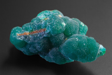 Macro natural Cuprian Adamite isolated on dark grey black background  