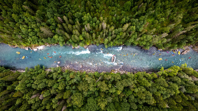 Group of friends spending time on the river enjoying kayaking and rafting together