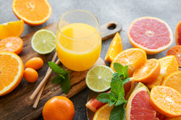 Glass of juice and citrus fruits