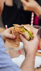People eating burger at the festival food court, Eating fast food.