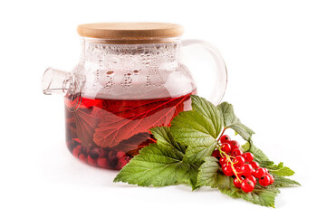 Tea made from berries and leaves of black and red currants in a transparent glass teapot on a white isolated background. A drink rich in vitamin C. A useful alternative to pills for colds and flu.