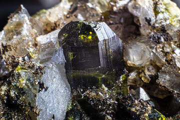 Ultra macro picture of small quartz points with one dark green epidote spike on matrix