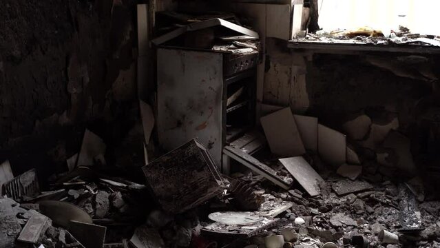 The apartment of the inhabitants after the evacuation during the bombing of a peaceful city. Left belongings of residents. Bombed apartments. Fire in the house. Traces of hits from. Irpin. Ukraine.