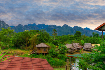 Fototapeta na wymiar Vang Vieng Laos a beautiful city on the river with huge rising mountains and slow flowing river. 