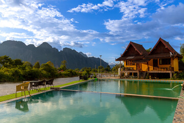 Naklejka premium Vang Vieng Laos a beautiful city on the river with huge rising mountains and slow flowing river. 