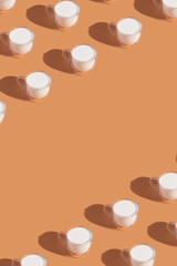 Milk in a glass pattern on a orange colored background, dairy diet concept. Copy space