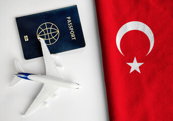 Flag of Turkey with passport and toy airplane. Flight travel concept
