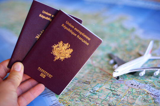 French passport with blurred map in background - travel concept