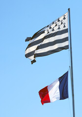 View of the French flag and Breton flag flying side by side in Brittany, France - obrazy, fototapety, plakaty