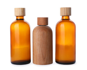 Different bottles of essential oil on white background
