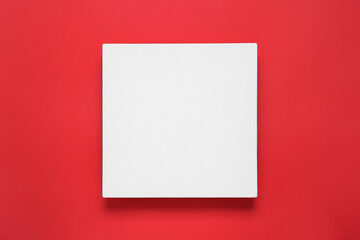 Blank canvas on red background, top view. Space for design