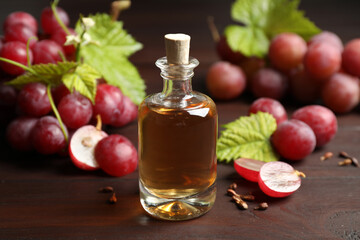 Bottle of natural grape seed oil on wooden table. Organic cosmetic