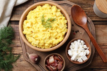 Tasty banosh served with brynza and pork cracklings on wooden table, flat lay. Traditional Ukrainian dish