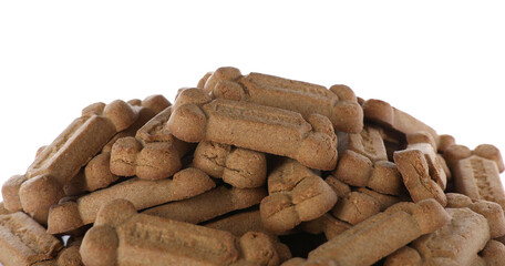 Pile of bone shaped dog cookies on white background, closeup