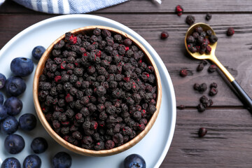 Freeze dried and fresh blueberries on wooden table, flat lay
