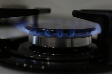 Fototapeta na wymiar Modern kitchen stove with burning gas, closeup